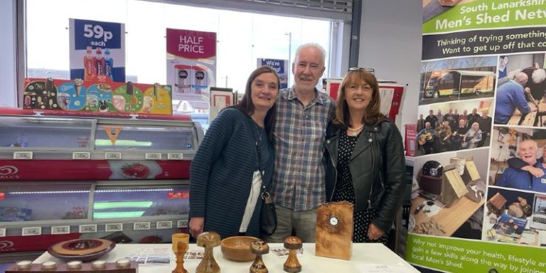 man and two women posing in store