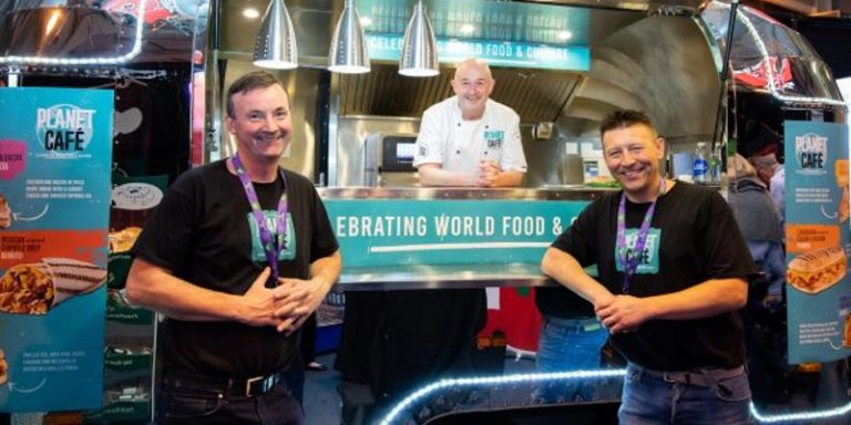 three men in front of stove