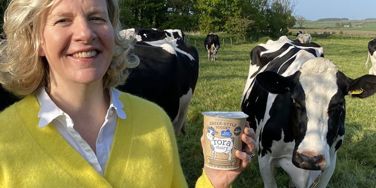 Woman with cows in background