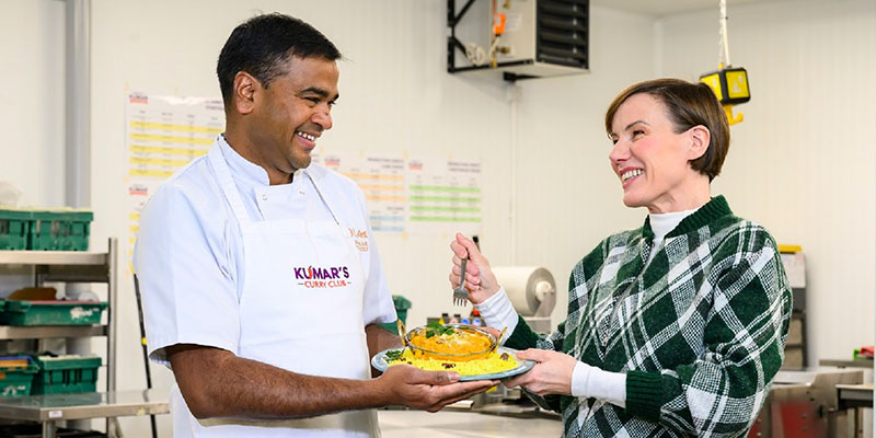 Man and woman holding Indian meal