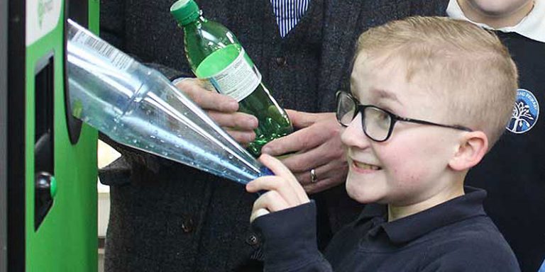 Child using reverse vending machine