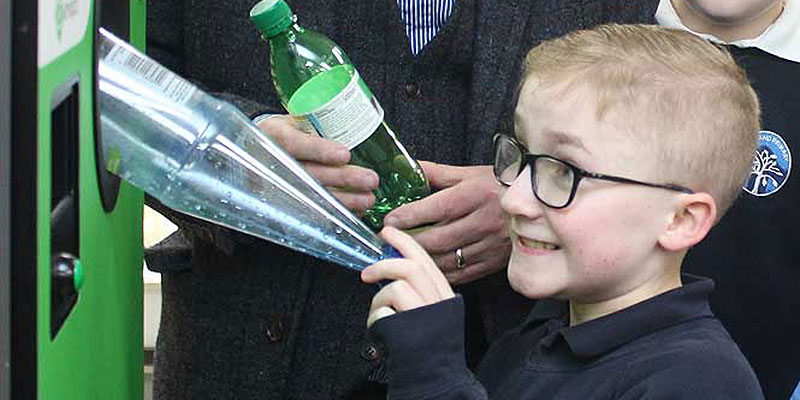 Child using reverse vending machine