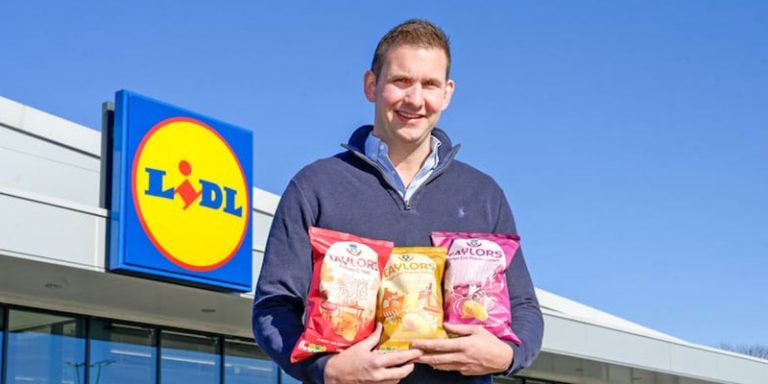 Man holding crisps outside Lidl store